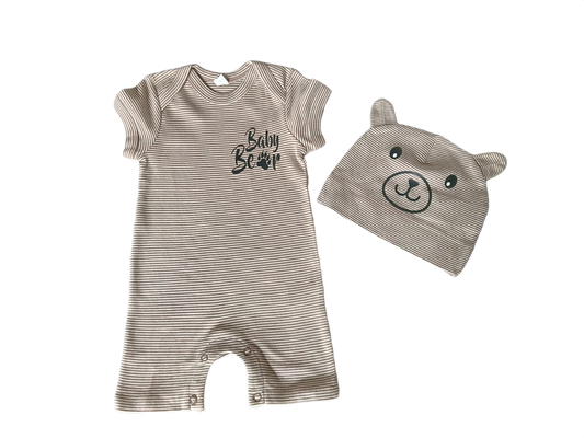 A baby clothing set featuring a short-sleeve ribbed romper and a matching bear-face hood, both in a light taupe-beige color with black details