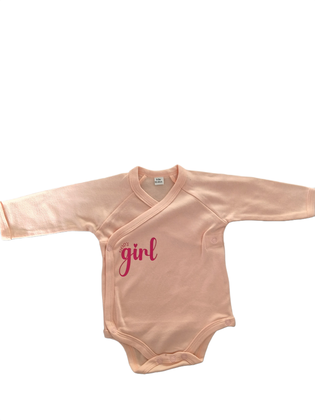A long-sleeve baby bodysuit in a soft peach-pink color, featuring a light pink 'God's Girl' text graphic on the chest.